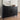 Black sideboard with decorative items against a neutral wall.