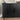 Black ribbed sideboard with decorative items on a neutral background