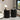 Two black side tables with decorative items in a living room setting.