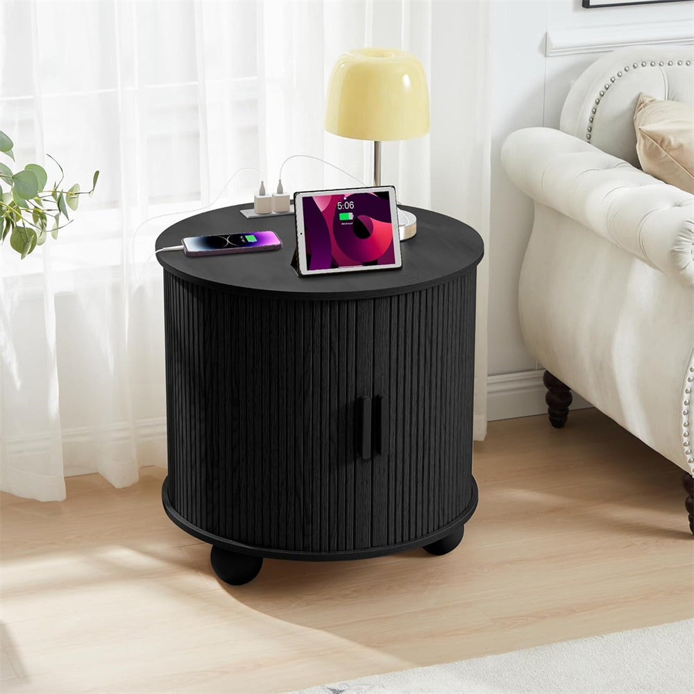 Black side table with electronic devices in a living room setting