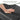 Hand touching a premium soft PU leather cushion with text about comfort and support.