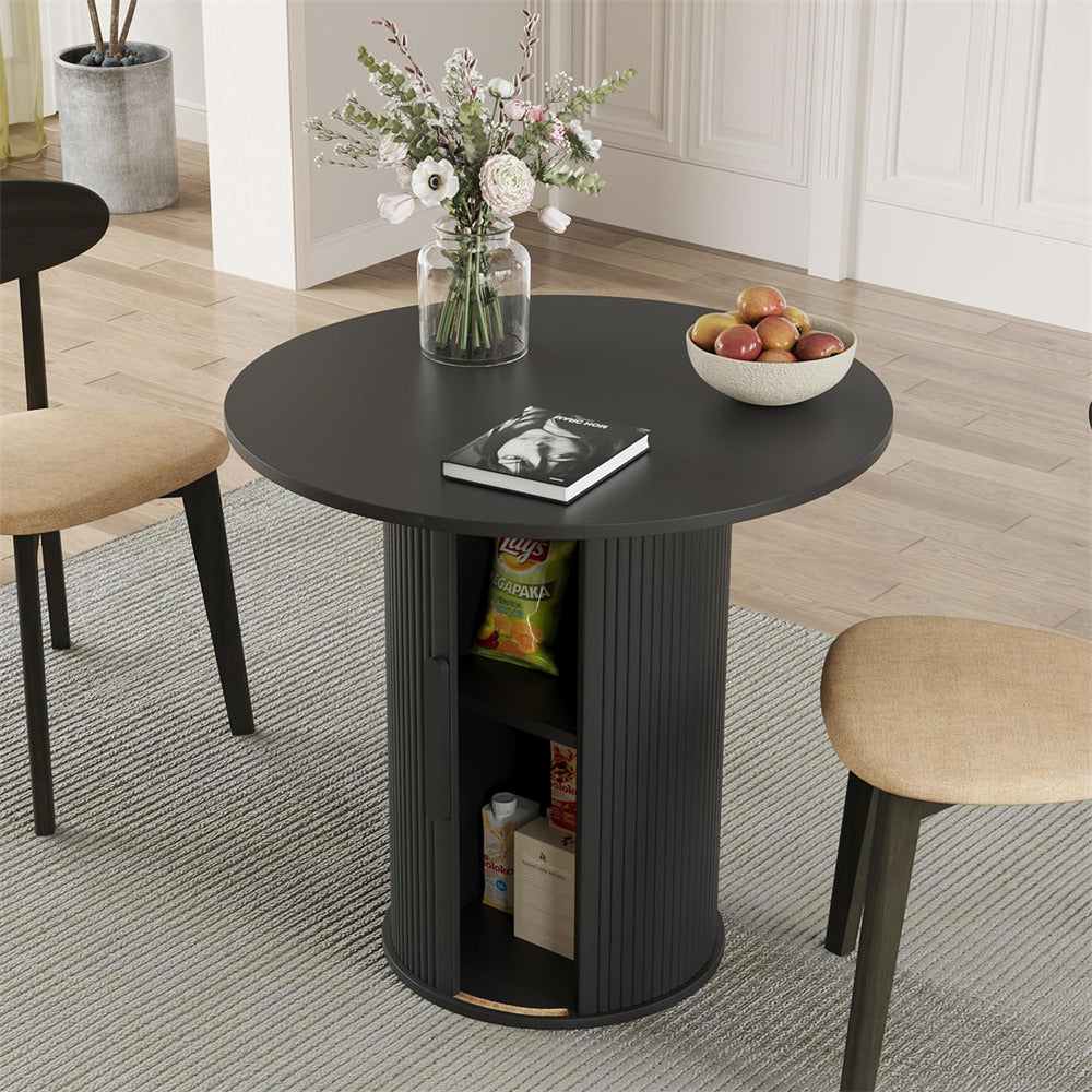Round black dining table with chairs in a room setting