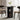Round black dining table with two chairs in a room with curtains and a plant.