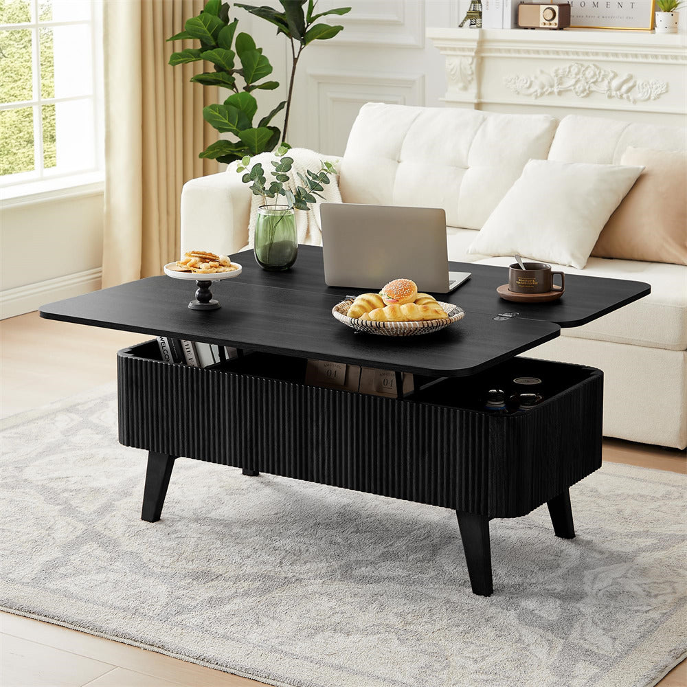 Black coffee table with a laptop, snacks, and a plant in a living room setting.