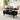 Black lift-top coffee table in a living room setting with a laptop, books, and decorative items.