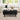 Living room with a black coffee table, white sofa, and decorative items.