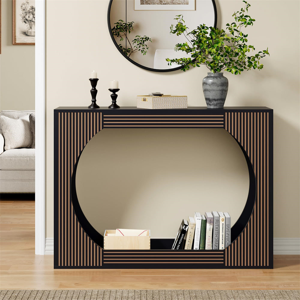 Decorative console table with mirror and books in a living room setting