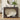 Decorative console table with mirror and books in a living room setting