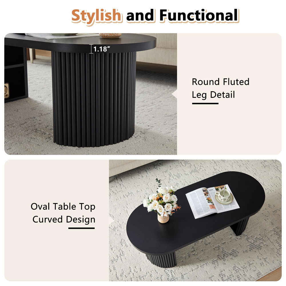 Black coffee table with round fluted leg detail and oval table top curved design, shown in a living room setting.