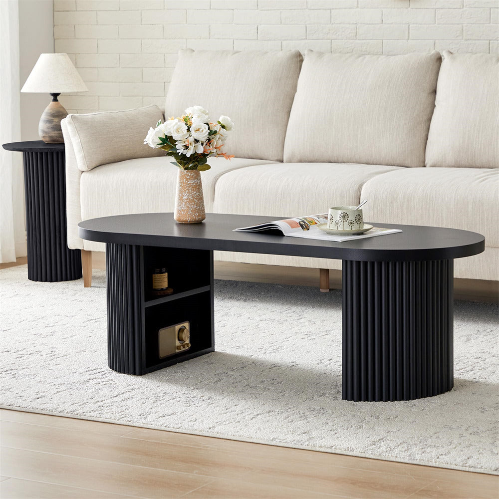 Black coffee table with decorative items in a living room setting