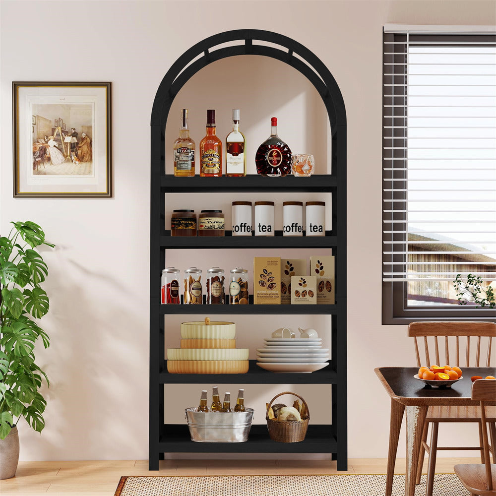 Black arch-shaped bookshelf with decorative items in a room with a window and plant.