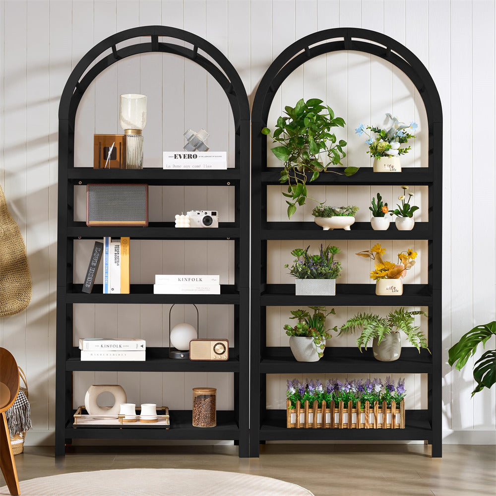 Black bookshelf with decorative items against a white wall