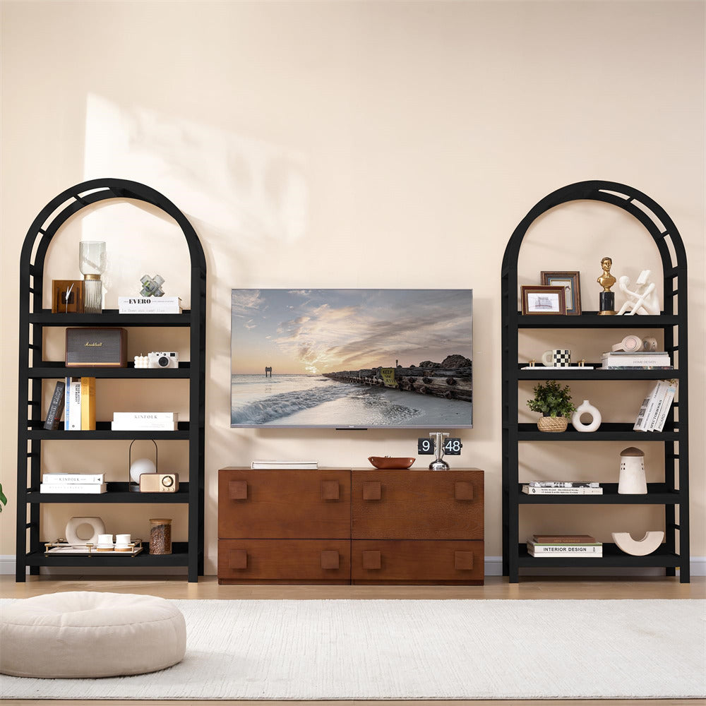 Living room setup with black arch bookshelves, wooden cabinet, and wall art.