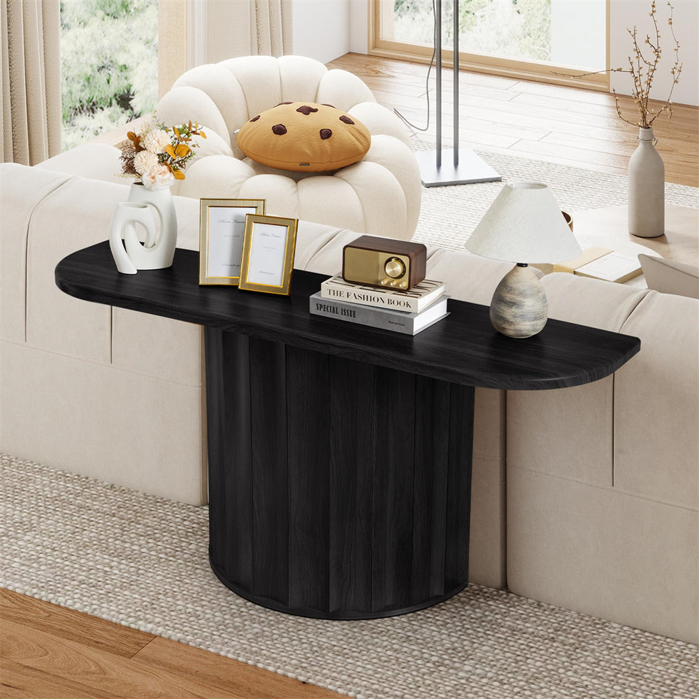 Black console table in a living room setting with decor items.