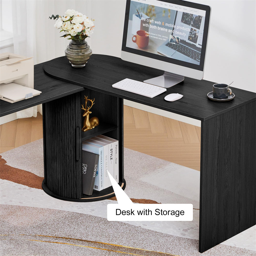 Black L-shaped desk with storage shelves, computer setup, and decor items in a room.