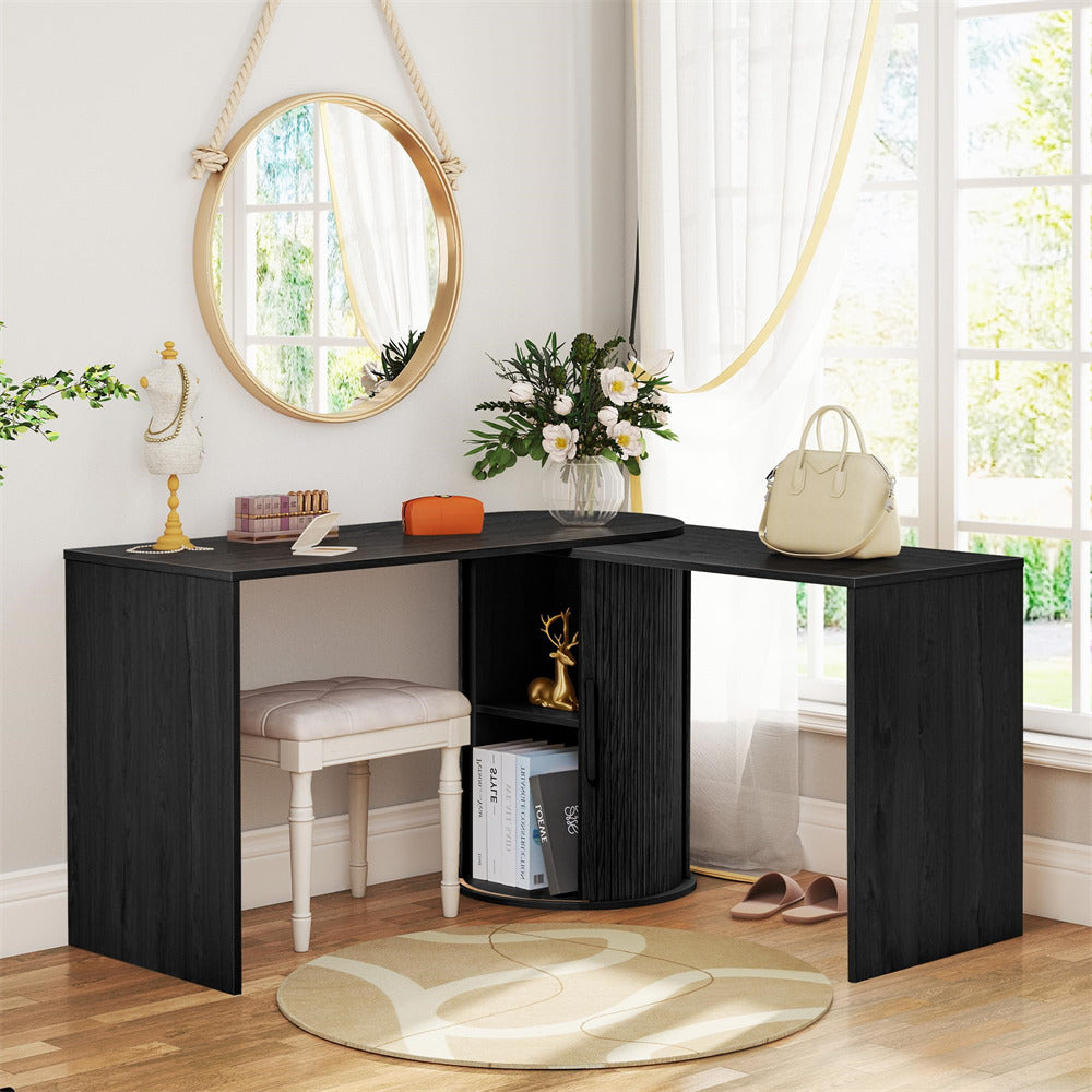 Black L-shaped desk in a room with a mirror, stool, and decorative items.