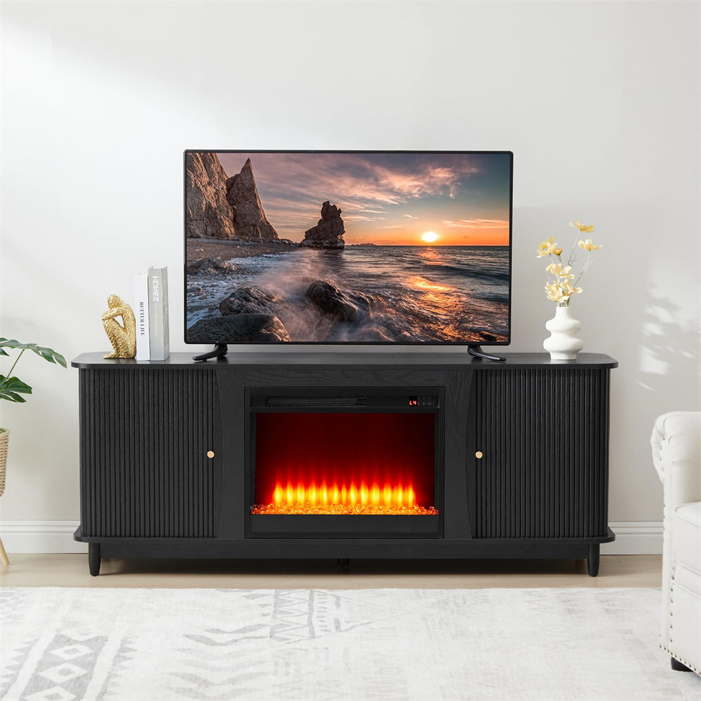 Black TV stand with electric fireplace and television displaying a sunset scene.