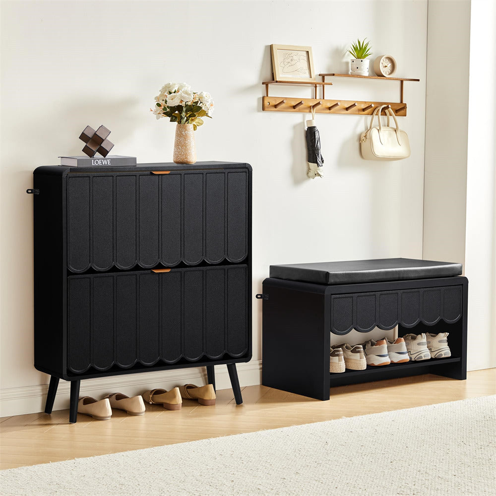 Black shoe storage cabinet and bench with shoes on a wooden floor.