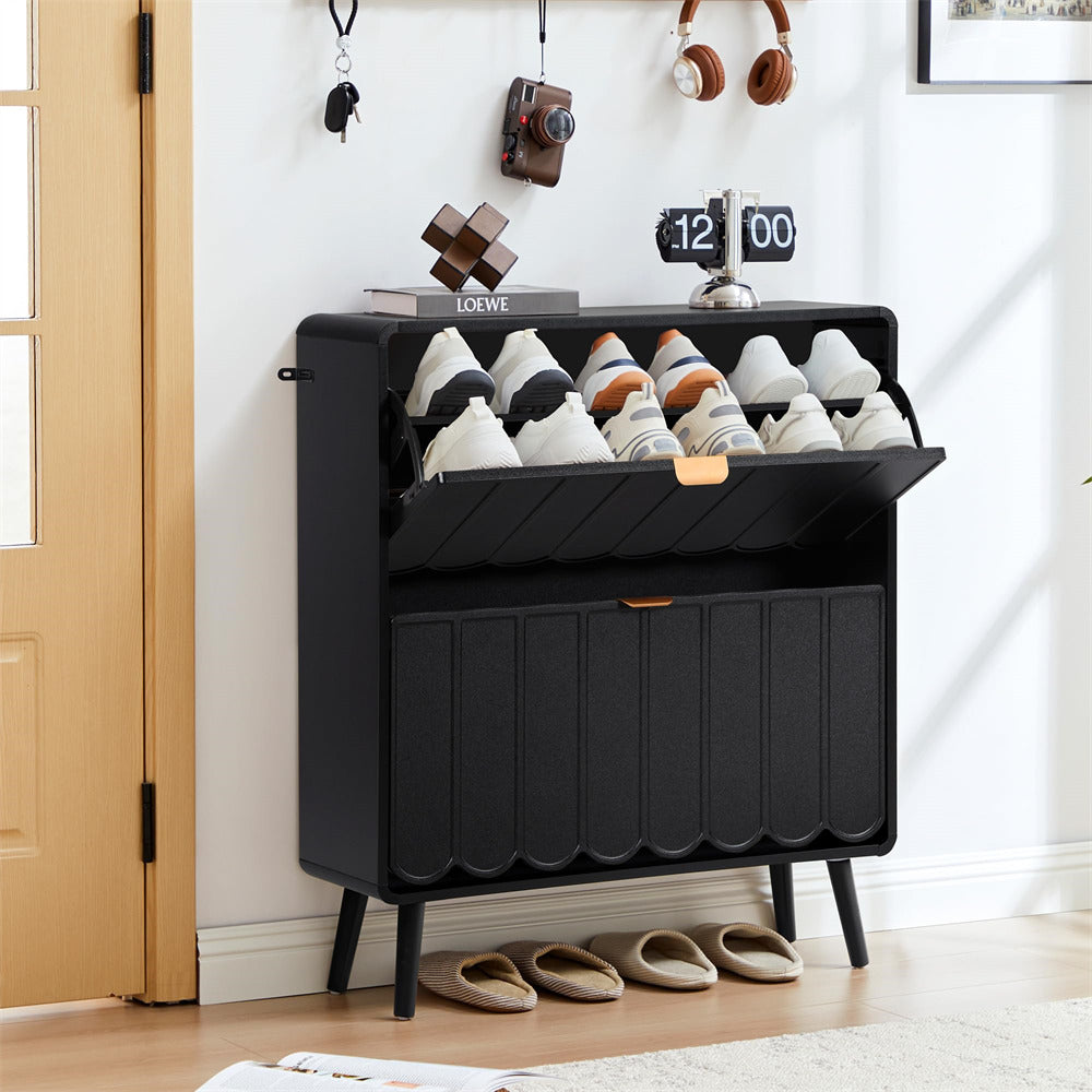 Black shoe cabinet with shoes inside, placed in a room with a door and decor.