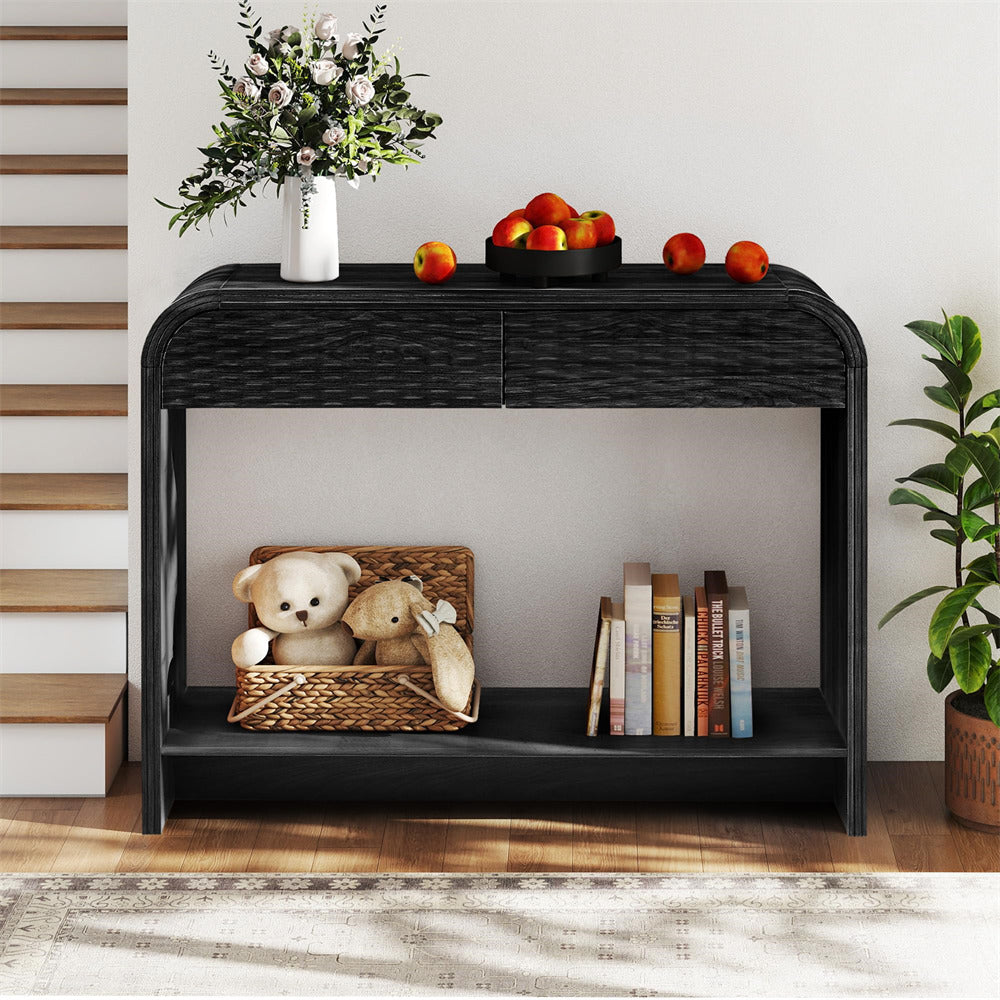Black console table with decorative items including teddy bears, books, and a vase.