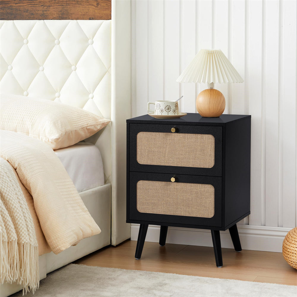 Black nightstand with two drawers next to a bed with white bedding and beige pillows.