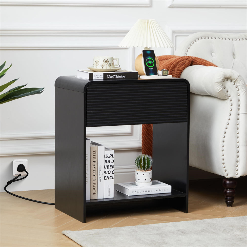 Black side table with books, a plant, and a smartphone in a living room setting.