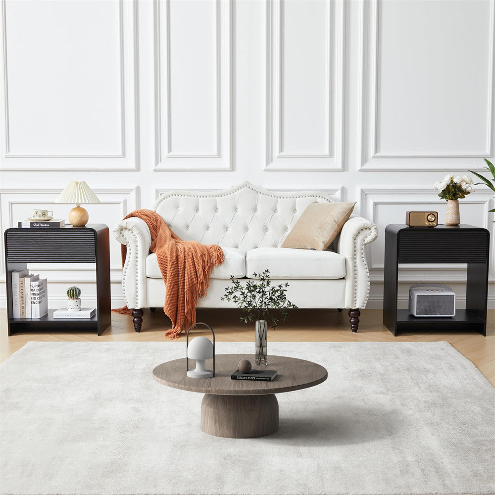 Living room with a white sofa, coffee table, and decorative items.