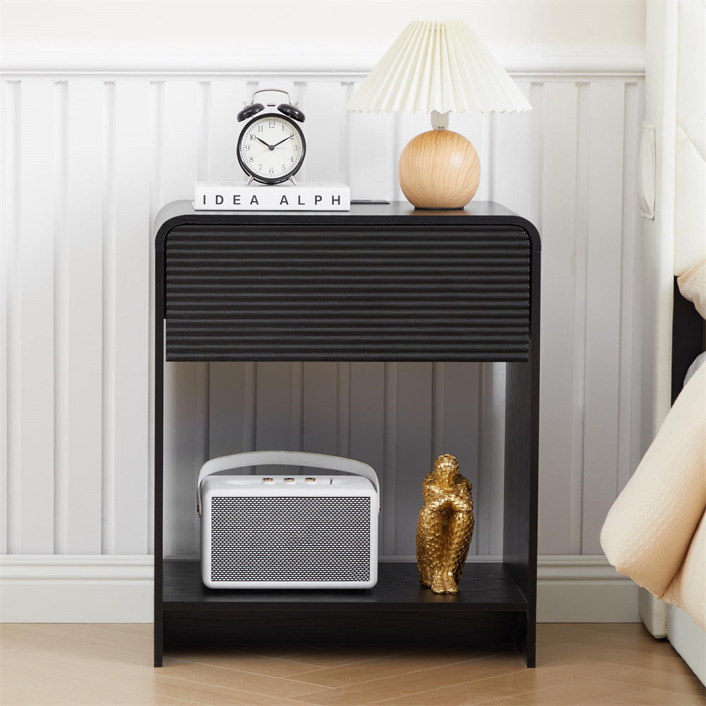 Black nightstand with decorative items in a bedroom setting