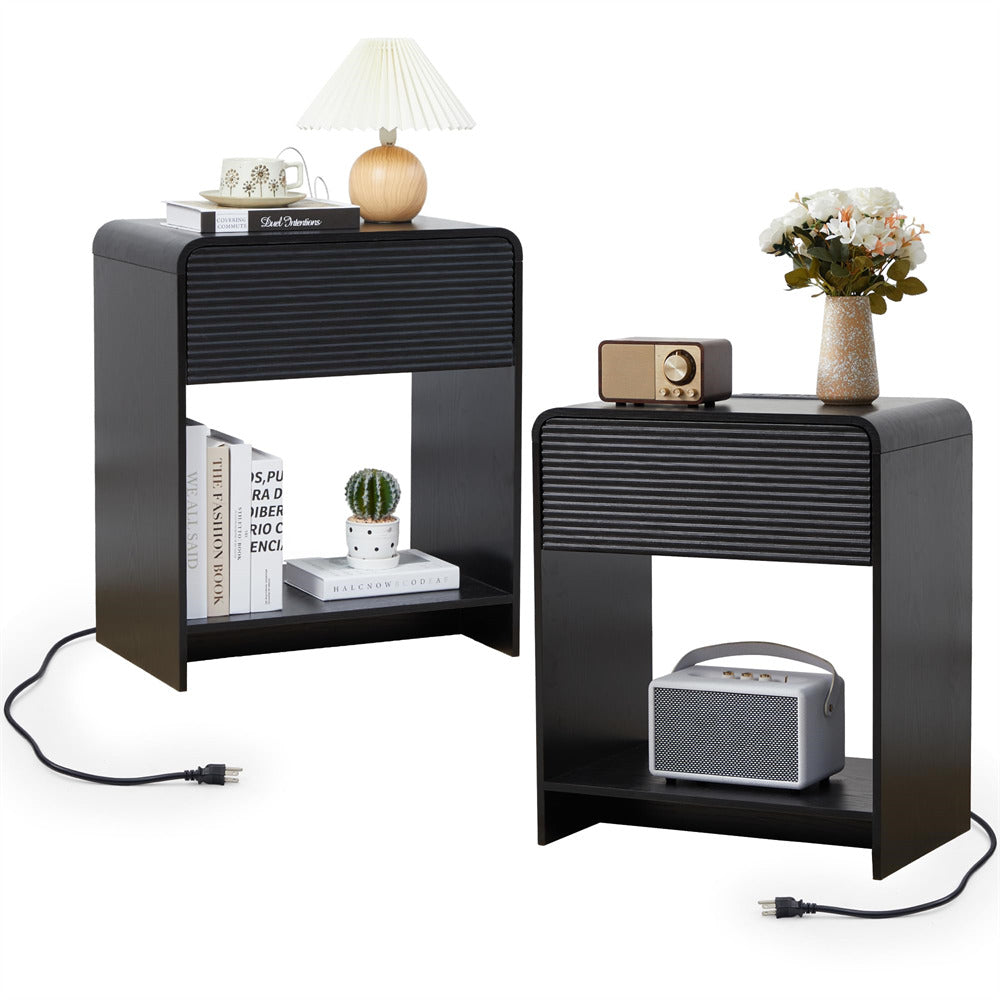Two black side tables with electronic devices and decor items on a white background