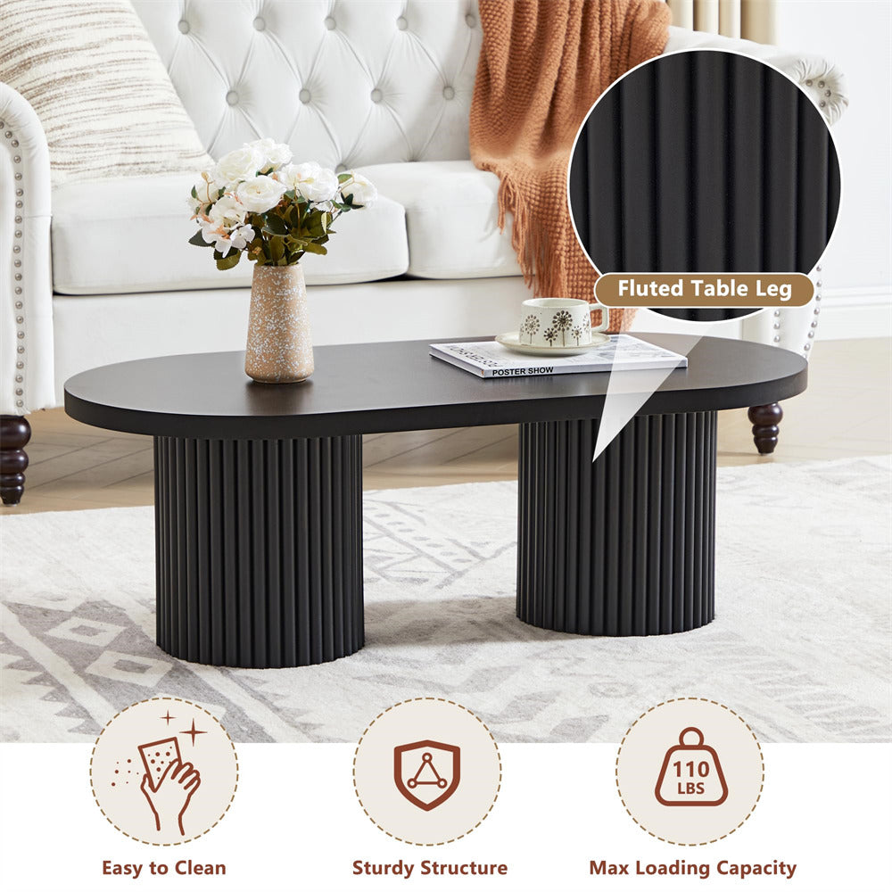 Black coffee table with fluted legs in a living room setting, featuring text on durability and features.