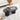 Black coffee table with decorative items in a living room setting