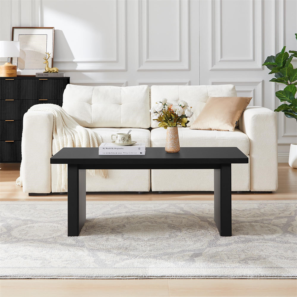 White sofa with a black coffee table in a living room setting