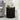 Black ribbed side table with decorative items in a living room setting