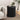 Black side table with decorative items in a living room setting