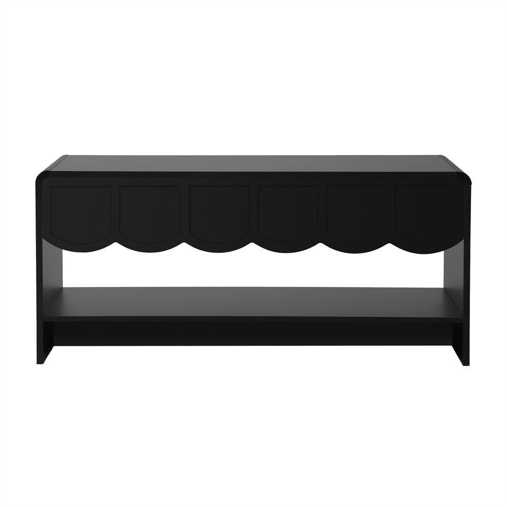 Black coffee table with scalloped edge design on a white background