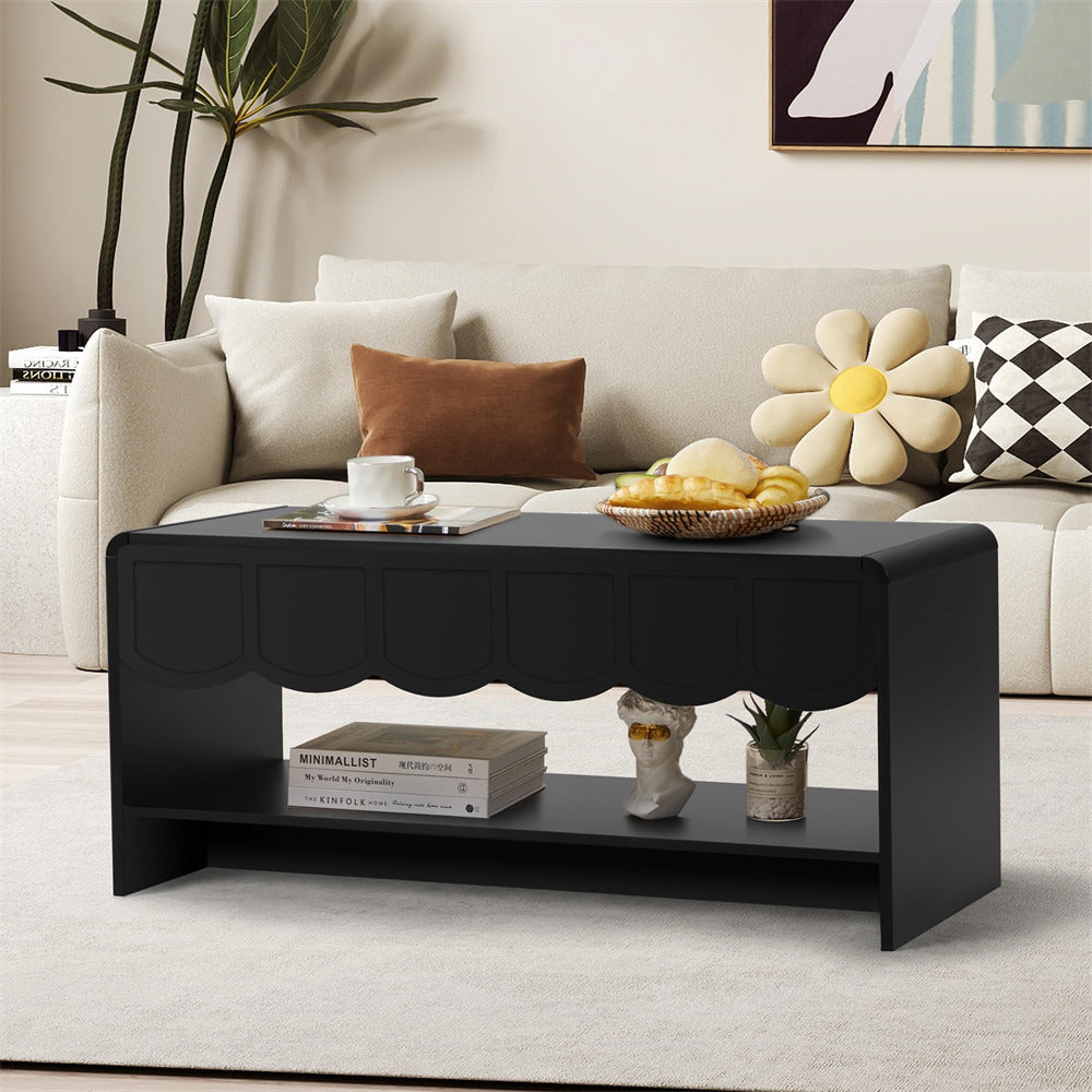 Black coffee table in a living room with a couch, pillows, and decorative items.