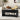 Black coffee table in a living room with a couch, pillows, and decorative items.