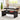Black lift-top coffee table in a living room setting with a laptop, mug, and books on top.