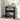 Black shoe rack with various shoes on a wooden floor in a room.