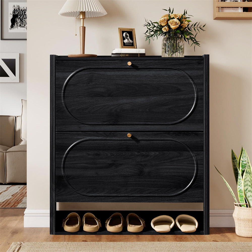 Black dresser with shoe storage in a room with decor elements.