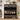 Black shoe rack with various shoes on a wooden floor in a room setting.