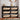 Black shoe rack with open drawers containing shoes in a room setting.