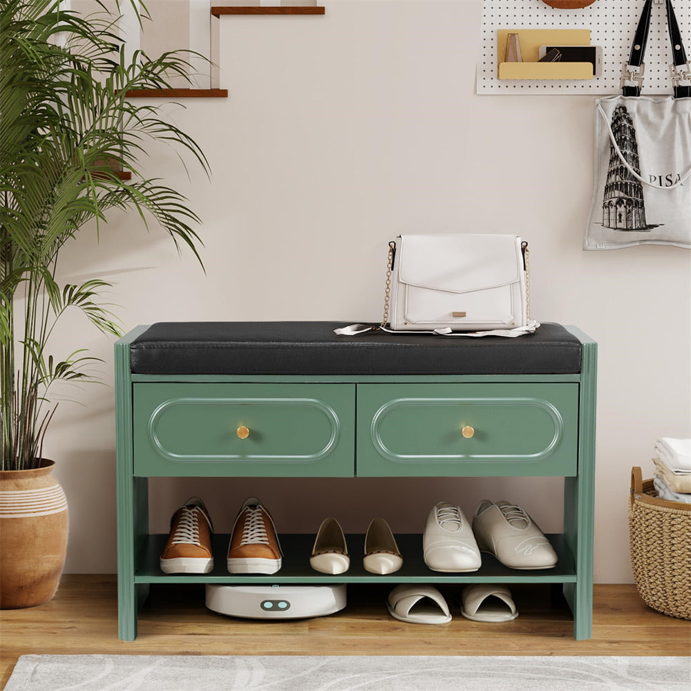 Green shoe cabinet with shoes on a wooden floor, plant to the left
