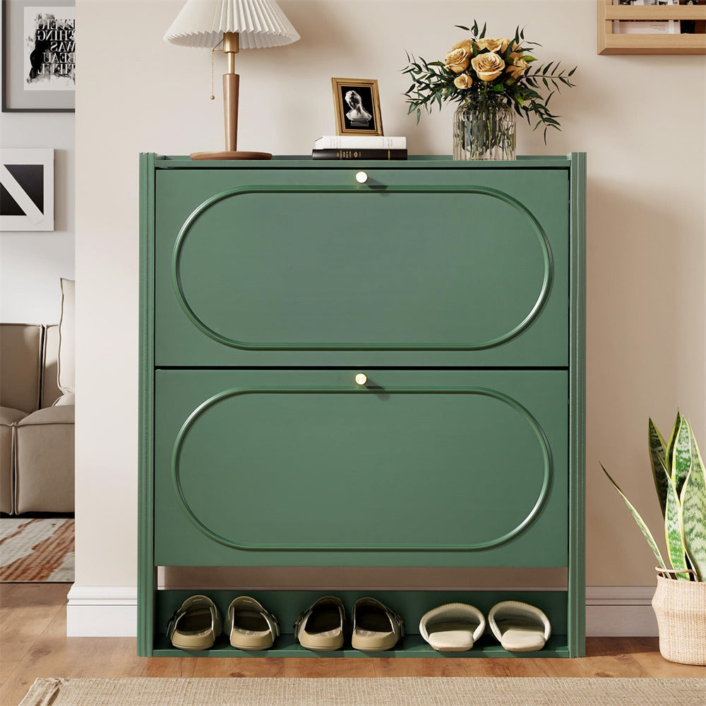 Green shoe cabinet with two doors and shoe storage space in a room setting.