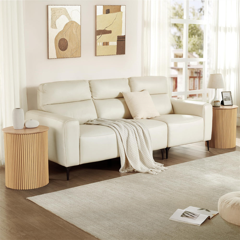 Beige sectional sofa in a living room with wooden side tables and abstract art on the wall.