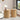 Two round wooden side tables in a living room setting with decor items.