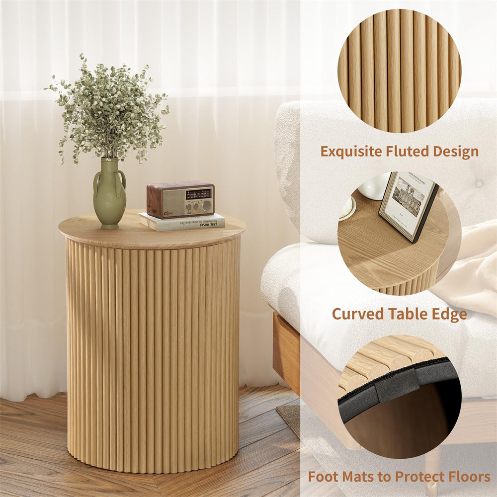 Wooden side table with fluted design, curved edge, and foot mats, placed in a room.