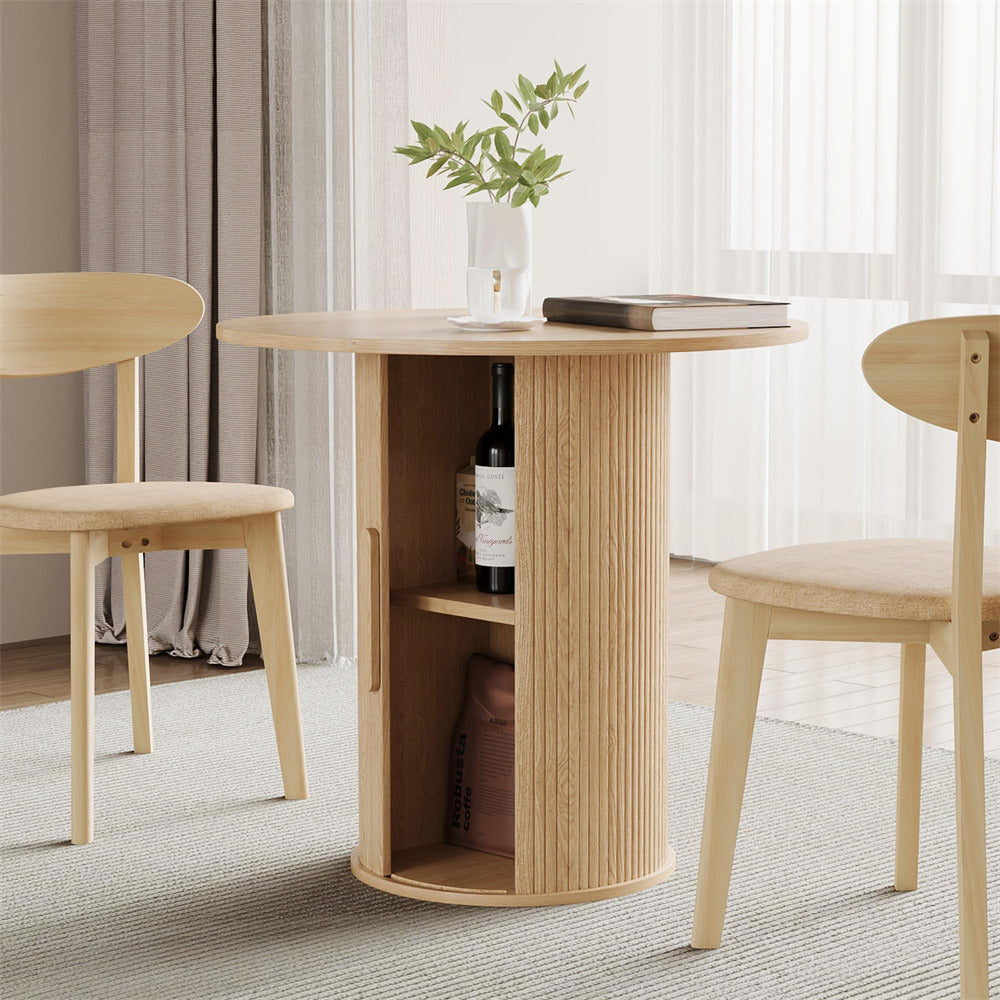 Wooden dining table with storage shelves and two chairs in a room with curtains.
