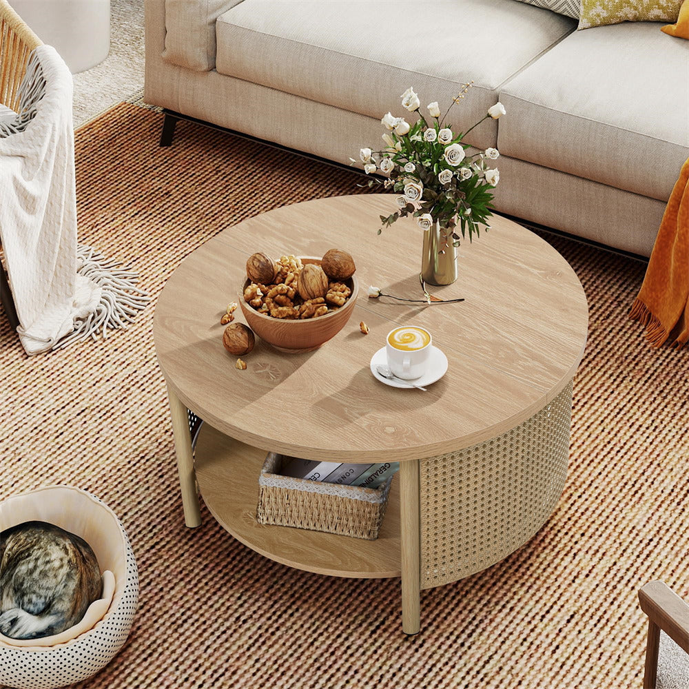 Round wooden coffee table with a bowl of snacks, cup of coffee, and vase of flowers in a living room.