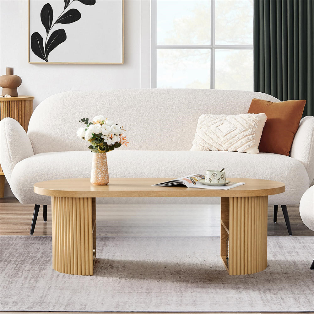 Modern living room with a white sofa, wooden coffee table, and decorative items.